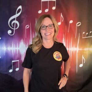 A woman standing in front of musical notes.