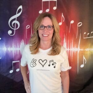 A woman standing in front of a music background.