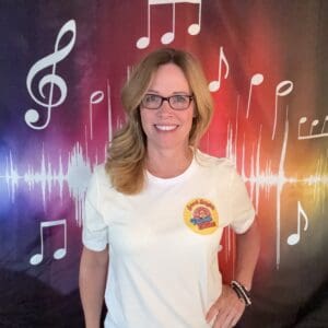 A woman standing in front of musical notes.