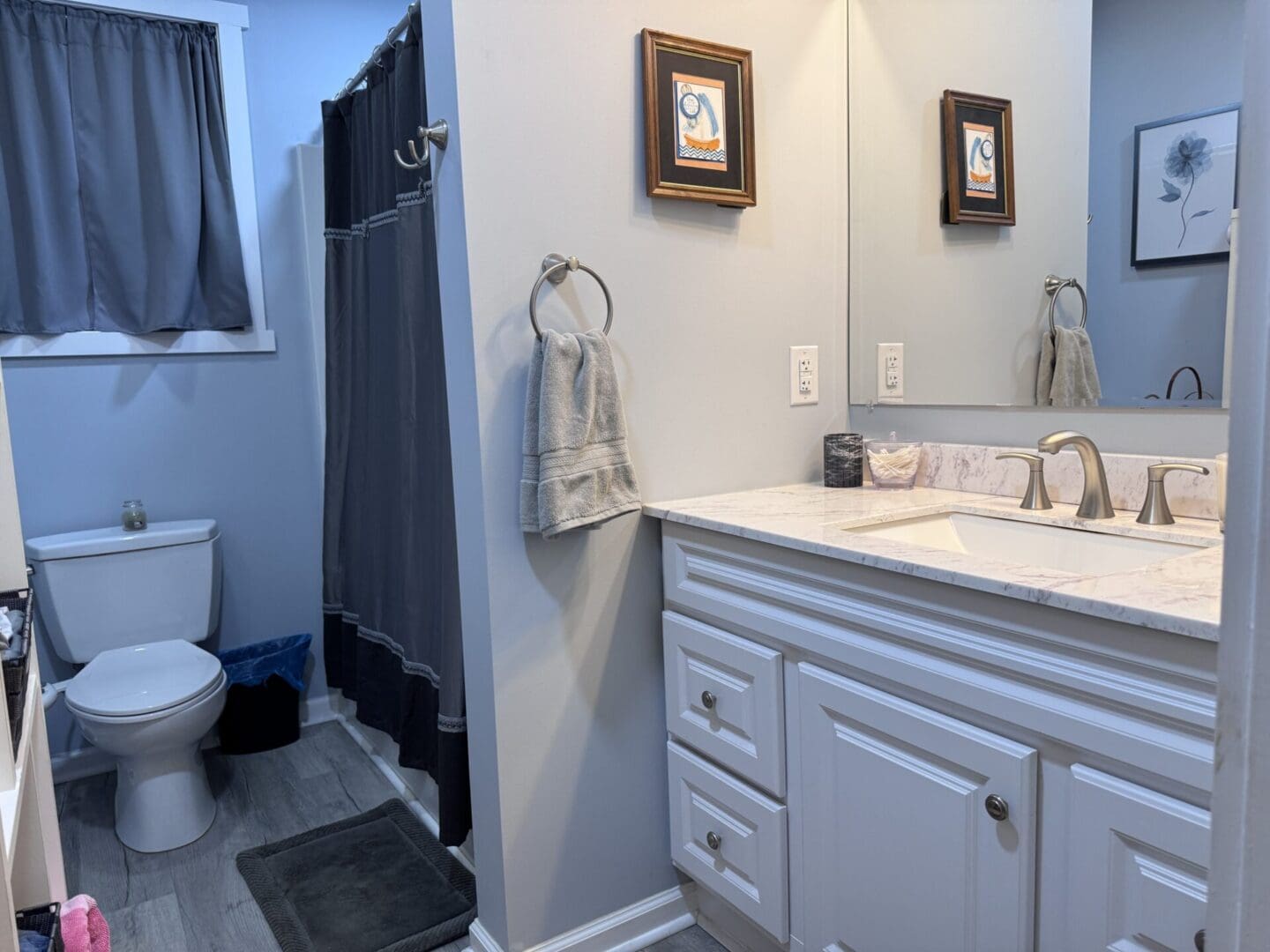 Modern bathroom with white vanity and mirror.