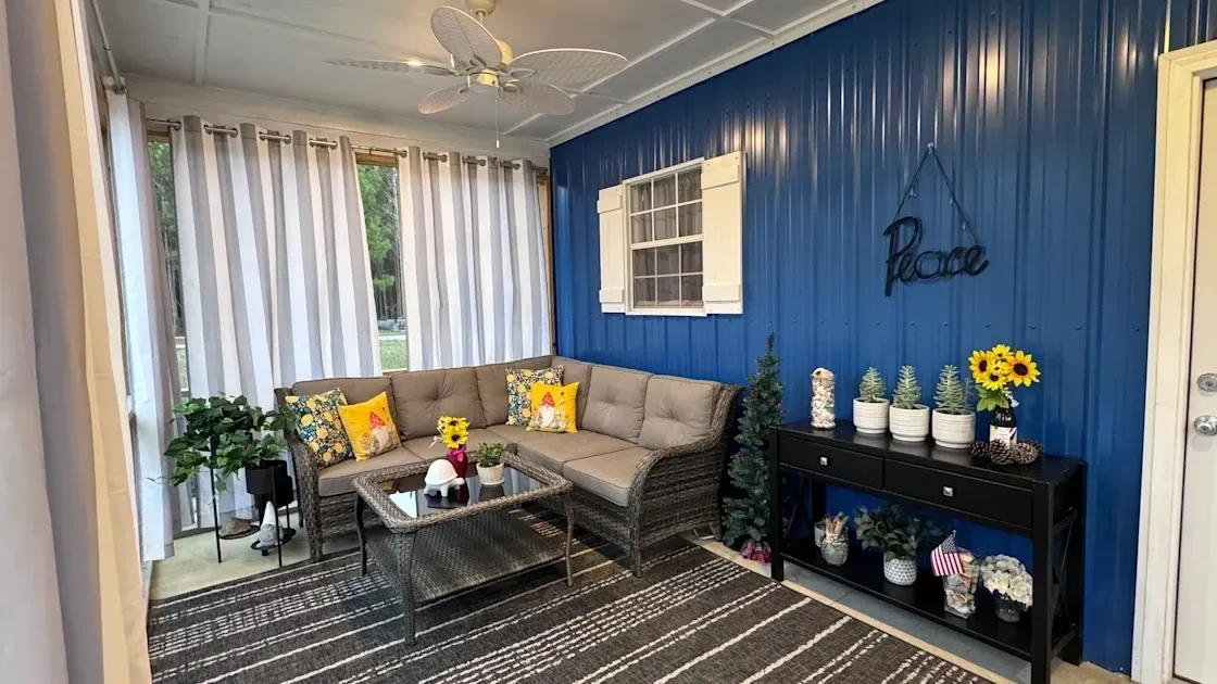 Cozy sunroom with blue accent wall.