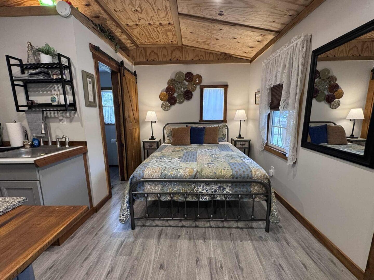 Cozy bedroom with rustic wooden ceiling.