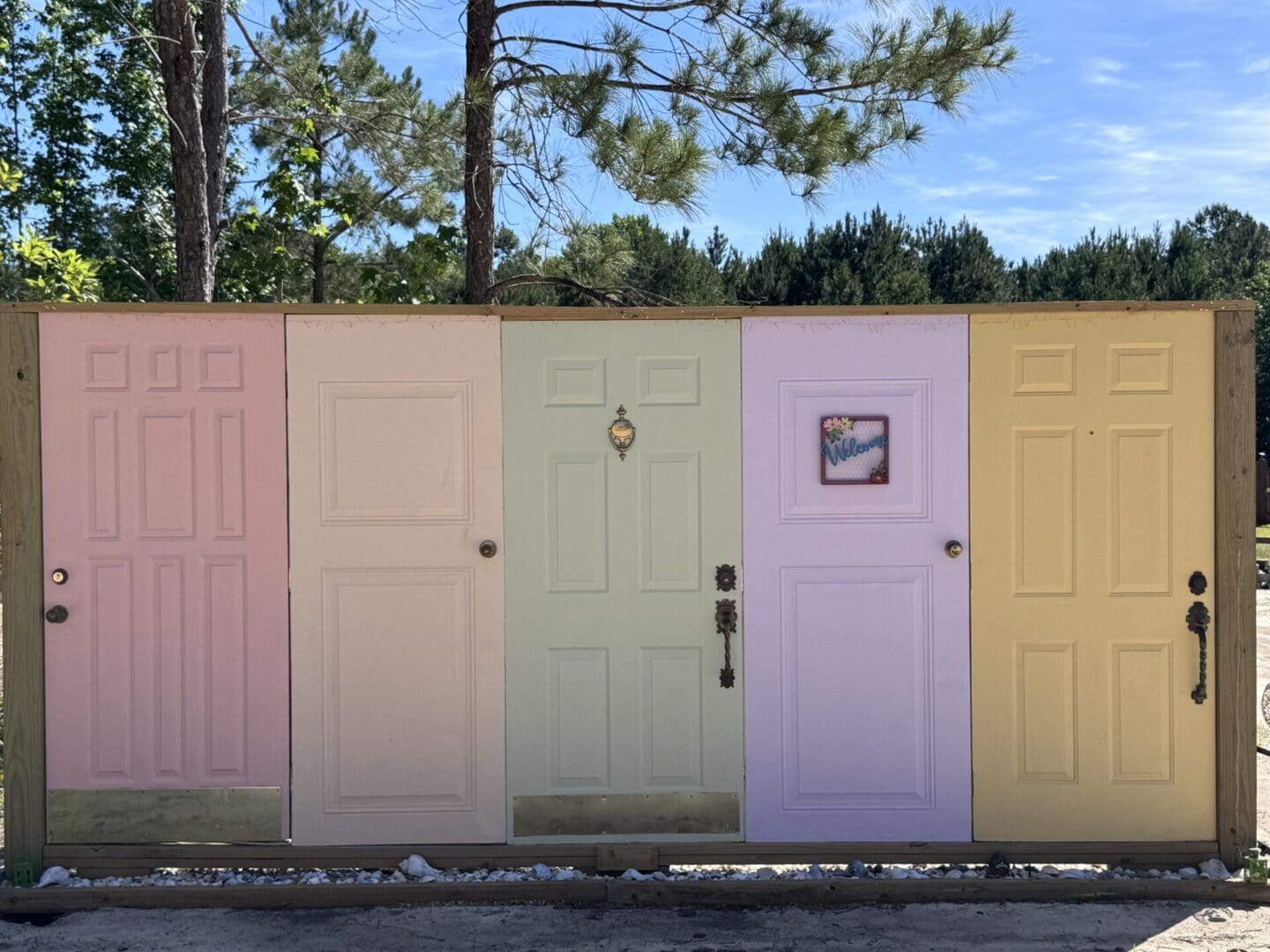 Colorful doors on a wooden outdoor display.