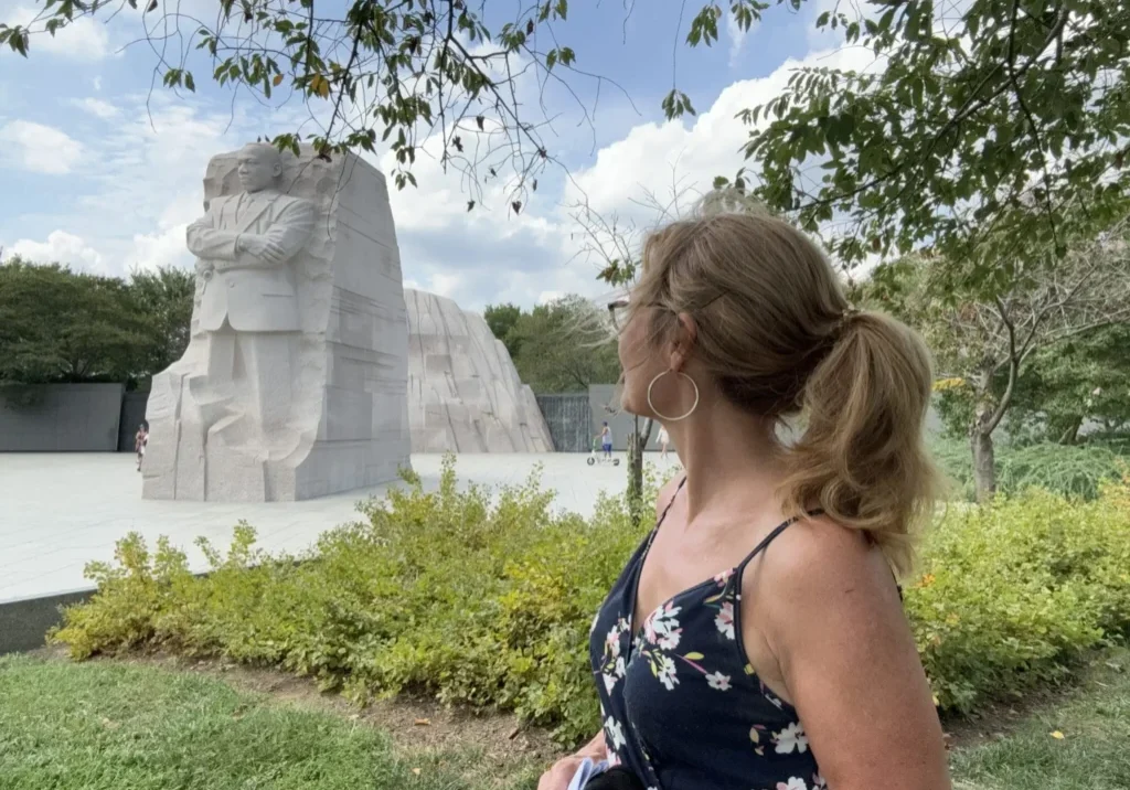 A woman standing in front of a statue.